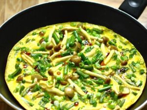 Garlic scape omelette with beech mushrooms and oyster sauce