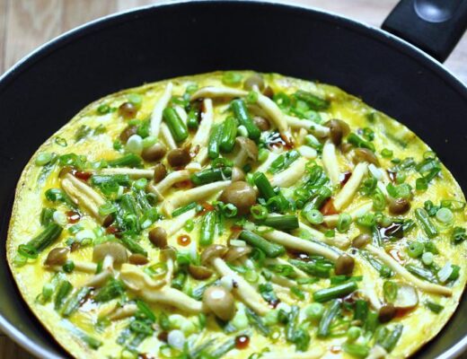 In many countries, garlic scapes are highly prized for their mild garlic flavor and tender-crisp texture. They work wonderfully with beech mushrooms in this omelet.