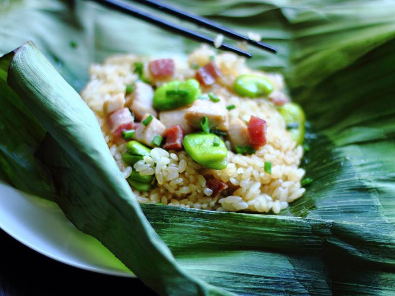 This dish is adapted from the famous Cantonese dish glutinous rice with chicken in lotus leaves, or lo mai gai. Fava beans are added for their wonderful flavor, and banana leaves are used instead of lotus leaves.
