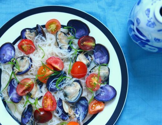 Clams and noodles make a good match in cooking. Here, the delicate medley of clams, tomatoes, and cellophane noodles creates a dish that's light and tasty.