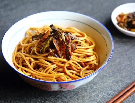 When the noodles are tossed with soy sauce and the fragrant scallion oil, they are coated with a powerful flavor punch, a beautiful golden color, and a marvelous sheen.