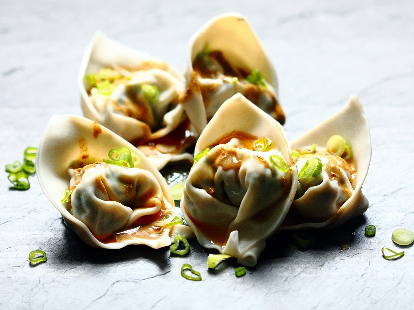 These cold wontons, with a vegetarian filling of tofu, bok choy, and dried shiitake mushrooms and draped in a sesame sauce, are great in warm weather.