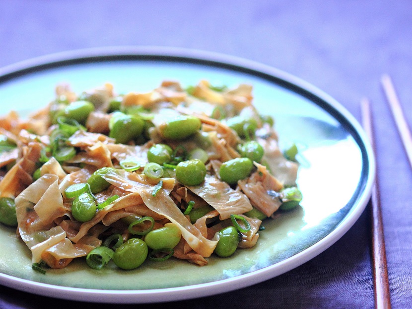 Tofu skin, with a nutty flavor and slightly chewy texture, pairs wonderfully with the crunchy green soybeans (aka edamame) in this quick stir-fry.