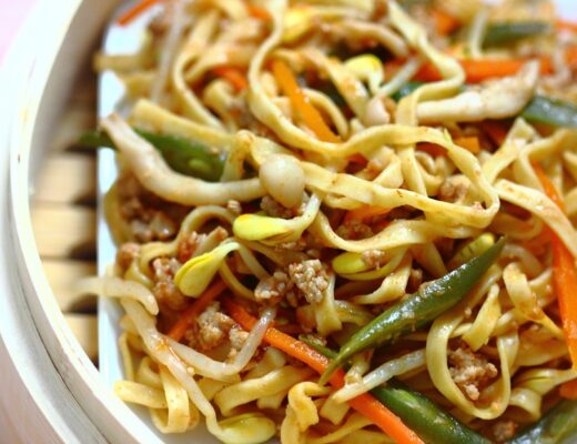 In this dish from Henan Province, the noodles are steamed twice to achieve great flavor and texture: the first time to cook partially and the second time to finish cooking with a saucy mixture of meat and vegetable sauce.