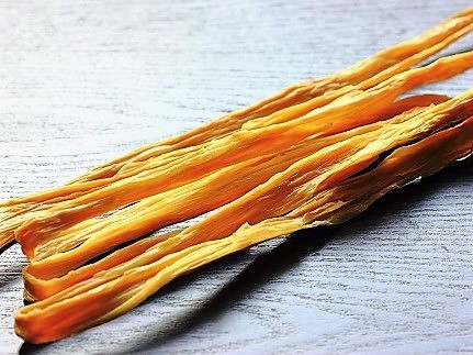 Tofu sticks, called fu zhu (腐竹) in Mandarin, are made from thin layers of tofu skin that are dried while hung vertically like sticks.