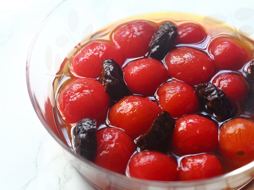 These cherry tomatoes, peeled and steeped in prune dressing, are delicious treats in the summer.