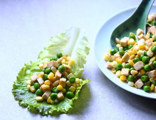 Stir-fried sweet corn, peas, pressed tofu, and pine nuts, wrapped in crisp lettuce leaves.