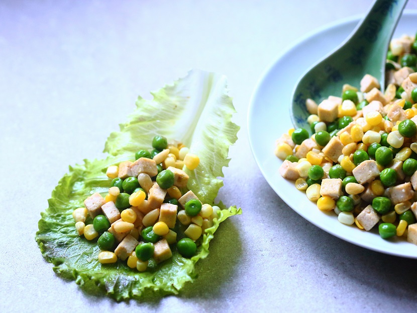 Stir-fried sweet corn, peas, pressed tofu, and pine nuts, wrapped in crisp lettuce leaves.