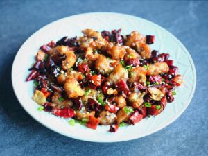 In this stunning dish from Sichuan, the chilies and peppercorns lend their wonderful aromas to the fried chicken pieces while giving them a gentle heat and a subtle tingling effect.